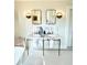 Elegant bathroom features a marble double vanity with brass fixtures and accents and penny tile flooring at 2066 Wappoo Dr, Charleston, SC 29412