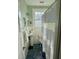 Bright, airy bathroom featuring blue tile floors, pedestal sink, and striped curtain at 2066 Wappoo Dr, Charleston, SC 29412