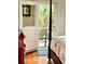 Bedroom with tiger patterned bedding, hardwood floors, red chest of drawers and door to porch at 2066 Wappoo Dr, Charleston, SC 29412