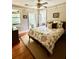 Comfortable bedroom boasts a ceiling fan, windows and French doors to porch for natural light and access at 2066 Wappoo Dr, Charleston, SC 29412