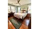 Spacious bedroom with a large bed, hardwood floors, and plenty of natural light at 2066 Wappoo Dr, Charleston, SC 29412
