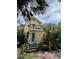 Charming two-story home with a balcony, teal front door, and beautifully landscaped yard at 2066 Wappoo Dr, Charleston, SC 29412