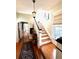 Hallway with wood floors leads to stairs and a glimpse of the kitchen at 2066 Wappoo Dr, Charleston, SC 29412