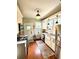 A well-lit kitchen featuring white cabinets, stainless steel appliances, and hardwood floors at 2066 Wappoo Dr, Charleston, SC 29412