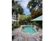 Backyard pool features a brick surround, lounge seating, and tropical landscaping at 2066 Wappoo Dr, Charleston, SC 29412