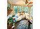 Sunroom with patterned floor, large windows and comfortable seating at 2066 Wappoo Dr, Charleston, SC 29412