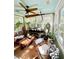 Bright sunroom filled with natural light, eclectic decor, and lush plants, creating a relaxing space at 2066 Wappoo Dr, Charleston, SC 29412