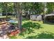 Aerial view of the backyard, with mature trees, shed, patio, and playset at 207 Littlejohn St, Summerville, SC 29483
