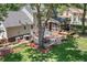 Aerial view of landscaped backyard featuring a brick patio and screened-in porch at 207 Littlejohn St, Summerville, SC 29483