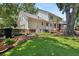 Well-manicured backyard features a lush lawn, charming landscaping, and lovely brick patio at 207 Littlejohn St, Summerville, SC 29483