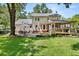 Expansive backyard featuring a well-manicured lawn, patio, deck, and inviting outdoor spaces at 207 Littlejohn St, Summerville, SC 29483