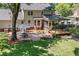 Landscaped backyard featuring a brick patio, outdoor dining area, and a screened porch at 207 Littlejohn St, Summerville, SC 29483