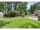 Large, grassy backyard with metal carport and gated access in a tranquil setting at 207 Littlejohn St, Summerville, SC 29483