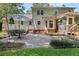 Charming brick patio with outdoor dining set and string lights for cozy evening gatherings at 207 Littlejohn St, Summerville, SC 29483