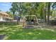 Expansive backyard with a wooden swing set and a well-maintained lawn at 207 Littlejohn St, Summerville, SC 29483