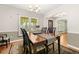 Elegant dining room with a large window, stylish rug, and ample seating at 207 Littlejohn St, Summerville, SC 29483