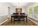Comfortable dining room with a view of the outdoor scenery and an elegant cabinet at 207 Littlejohn St, Summerville, SC 29483