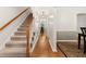 Bright entryway with hardwood floors, carpeted stairs, and access to other rooms at 207 Littlejohn St, Summerville, SC 29483
