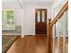 Welcoming foyer with wood floors, staircase, and decorative wood front door at 207 Littlejohn St, Summerville, SC 29483