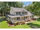 Charming two-story home featuring a spacious porch, manicured lawn, and beautiful landscaping at 207 Littlejohn St, Summerville, SC 29483