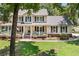 Charming two-story home featuring a spacious porch, manicured lawn, and beautiful landscaping at 207 Littlejohn St, Summerville, SC 29483