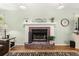 Close up of the brick fireplace with a decorative mantle and hearth at 207 Littlejohn St, Summerville, SC 29483