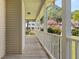 Wide front porch with a view of the neighborhood and blooming trees at 207 Littlejohn St, Summerville, SC 29483