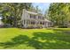 Charming two-story home featuring a spacious porch, manicured lawn, and beautiful landscaping at 207 Littlejohn St, Summerville, SC 29483