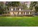 Charming two-story home featuring a spacious porch, manicured lawn, and inviting curb appeal at 207 Littlejohn St, Summerville, SC 29483