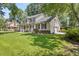 Charming two-story home featuring a spacious porch, manicured lawn, and attached garage at 207 Littlejohn St, Summerville, SC 29483