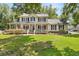 Charming two-story home featuring a spacious porch, manicured lawn, and inviting curb appeal at 207 Littlejohn St, Summerville, SC 29483