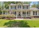 Charming two-story home featuring a spacious porch, manicured lawn, and inviting curb appeal at 207 Littlejohn St, Summerville, SC 29483