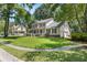 Charming two-story home featuring a spacious porch, manicured lawn, and attached garage at 207 Littlejohn St, Summerville, SC 29483