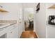 Hallway with access to a dining room, featuring hardwood floors and white walls at 207 Littlejohn St, Summerville, SC 29483