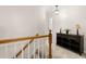 Upstairs hallway with carpet and dark wood console table with lamps and decor at 207 Littlejohn St, Summerville, SC 29483