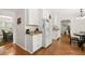 Charming kitchen featuring granite counters, white cabinetry, and hardwood floors at 207 Littlejohn St, Summerville, SC 29483