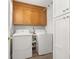 Functional laundry room with washer, dryer, and storage cabinets at 207 Littlejohn St, Summerville, SC 29483