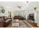 Inviting living room featuring a fireplace, leather sofas, and ample natural light at 207 Littlejohn St, Summerville, SC 29483