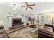 Comfortable living room with fireplace, wood floors, ceiling fan and french doors at 207 Littlejohn St, Summerville, SC 29483
