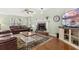 Cozy living room featuring a brick fireplace and hardwood floors and large leather sofas at 207 Littlejohn St, Summerville, SC 29483