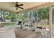Relaxing screened porch featuring classic rocking chairs and views of the lush backyard at 207 Littlejohn St, Summerville, SC 29483