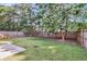 An expansive backyard featuring a lush lawn, a privacy fence, and mature shade trees at 210 Wildberry Ln, Goose Creek, SC 29445