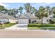 Charming single-story home with a two-car garage, well-manicured lawn, and lovely landscaping at 210 Wildberry Ln, Goose Creek, SC 29445