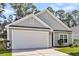 Charming home featuring a two-car garage, neutral siding, and well-maintained landscaping at 210 Wildberry Ln, Goose Creek, SC 29445
