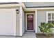 Inviting front entry with a decorative wood door and a well-manicured shrub at 210 Wildberry Ln, Goose Creek, SC 29445