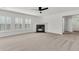 Bright living room with fireplace, fan, and plantation shutters on the windows at 210 Wildberry Ln, Goose Creek, SC 29445