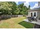 View of a spacious backyard with a table and chairs on a patio at 2106 Clipstone Dr, Ladson, SC 29456