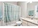 Cozy bathroom featuring neutral walls, a shower-tub combo with a striped curtain, and a granite vanity at 2106 Clipstone Dr, Ladson, SC 29456