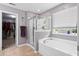 Beautiful bathroom featuring a soaking tub, a separate glass enclosed shower, and a view of the outdoors at 2106 Clipstone Dr, Ladson, SC 29456