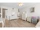 Bright bedroom with white walls, wood-look floors, with a white dresser and vanity at 2106 Clipstone Dr, Ladson, SC 29456
